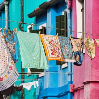 Towels drying on line in front of colorful houses
