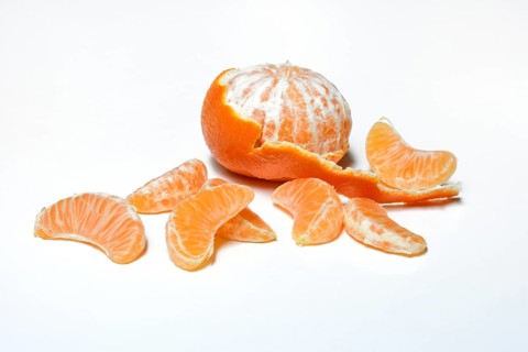 Half peeled clementine and clementine pieces