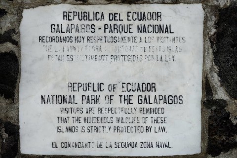 Old marble plaque with admonition to tourists