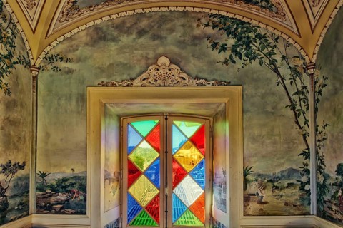 Stained glass window and azulejos tiles in a garden pavilion