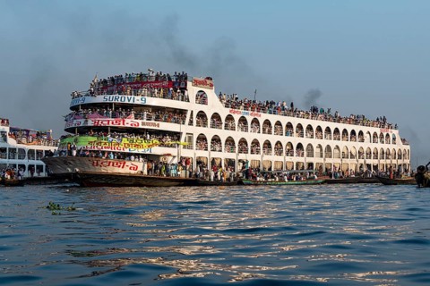 Overloaded passenger ferry with pilgrims on the Dhaka river