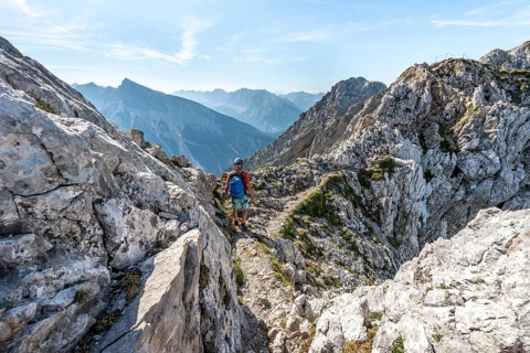 Mountaineer climbs a secured via ferrata