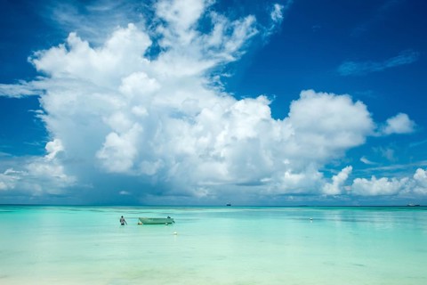Little motorboat in the turquoise waters of the beautiful lagoon of Funafuti