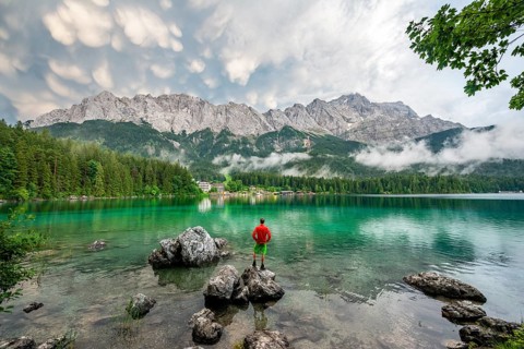 Young man standing on a rock on the shore