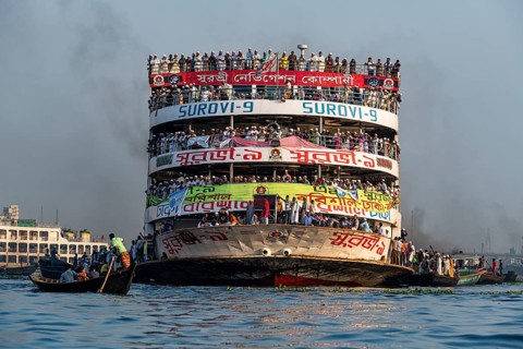 Overloaded passenger ferry with pilgrims on the Dhaka river