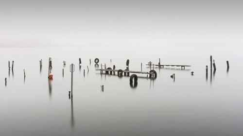 An old jetty in dense fog in the Kleiner Schwielochsee