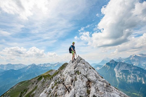 Mountaineer on a ridge on a secured fixed rope route