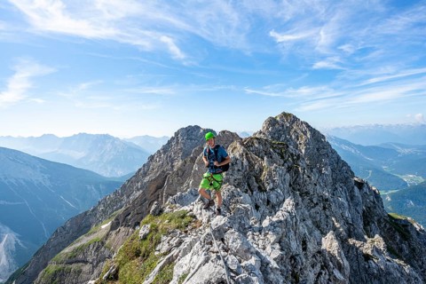 Mountaineer on a ridge on a secured fixed rope route