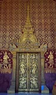 Splendid entrance door with carved half reliefs and decorative ornaments
