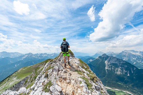 Mountaineer on a ridge on a secured via ferrata