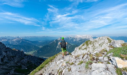 Mountaineer climbs on a secured fixed rope route