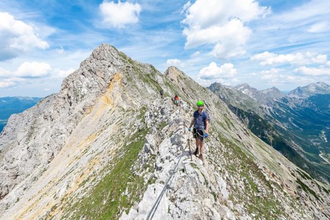 Mountaineer on a ridge on a secured fixed rope route