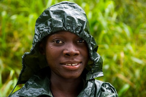 Pretty girl wearing a raincape smiling
