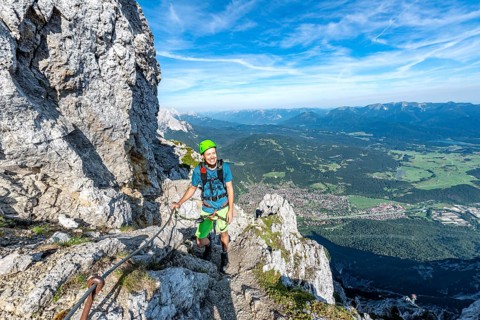 Mountaineer climbs on a secured fixed rope route