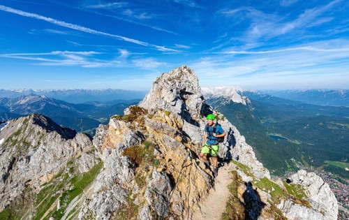 Mountaineer on a ridge on a secured via ferrata