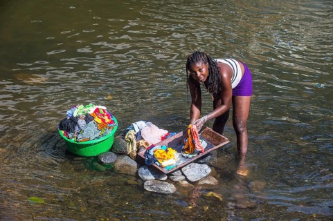 Woman washing her clothes in a river at the east coast of Sao Tome