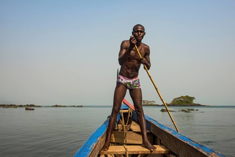 Man pushing his small boat on Banana islands