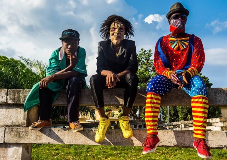 Boys in costums sitting on a wall