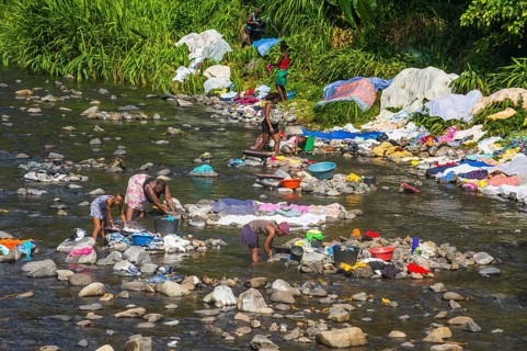 Women washing their clothes in a river at the east coast of Sao Tome