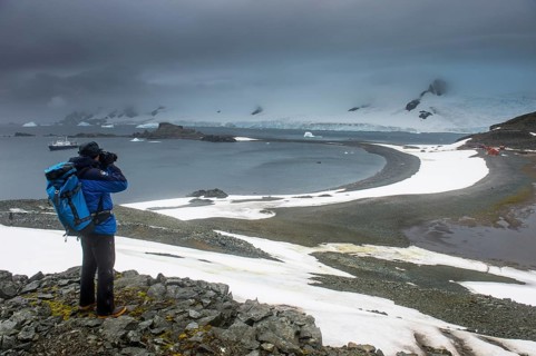Tourist photographing from an overlook over Half moon island