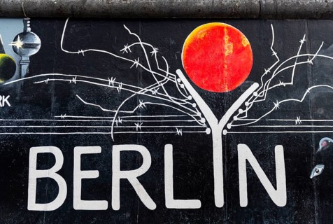 Mural Berlyn with lettering Berlin and symbolic wall with barbed wire