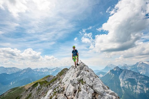 Mountaineer on a ridge on a secured fixed rope route