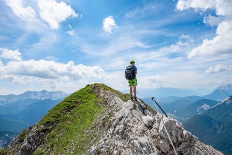 Mountaineer on a ridge on a secured fixed rope route