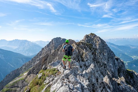 Mountaineer on a ridge on a secured fixed rope route