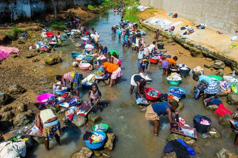 Women washing clothes in a river bed