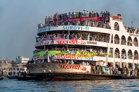 Overloaded passenger ferry with pilgrims on the Dhaka river