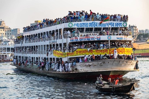 Overloaded passenger ferry with pilgrims on the Dhaka river