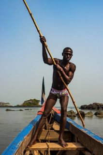 Man pushing his small boat on Banana islands