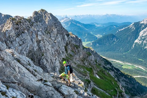 Mountaineer climbs on a secured fixed rope route
