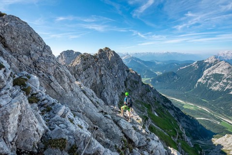Mountaineer climbs on a secured fixed rope route