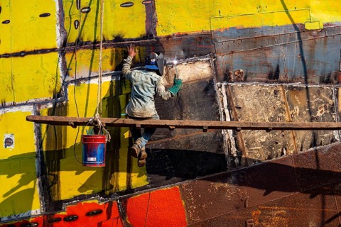 Man welding on a ship