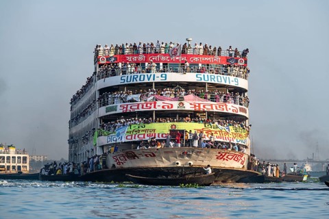 Overloaded passenger ferry with pilgrims on the Dhaka river