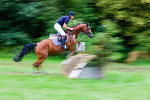 Rider over jumps obstacle with horse