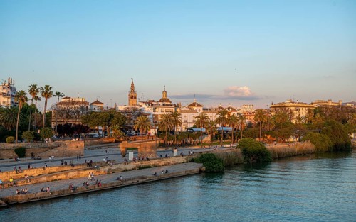 Waterfront Muelle de la sal at the river Rio Guadalquivir with Monumento a la Tolerancia