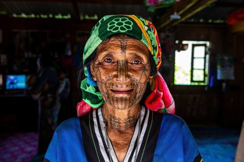 Chin woman with spiderweb tattoo