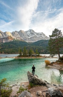 Young woman standing on a rock on the shore