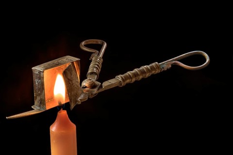 Biedermeier wick scissors with burning candle