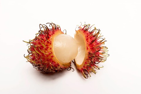 Rambutan whole and peeled on white background