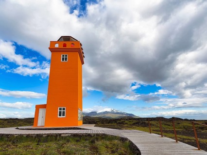 Orange lighthouse Skalasnagaviti or Svoertuloft with wooden boardwalk
