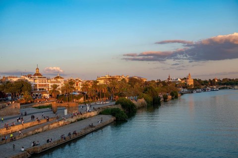 Waterfront Muelle de la sal at the river Rio Guadalquivir with Monumento a la Tolerancia