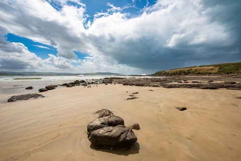 Sandy beach beach and rocks in Curio Bay