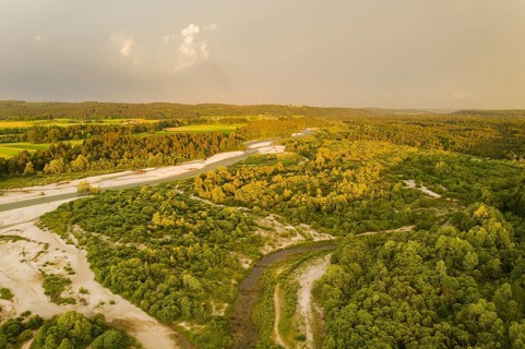 Isar in evening light with rain clouds