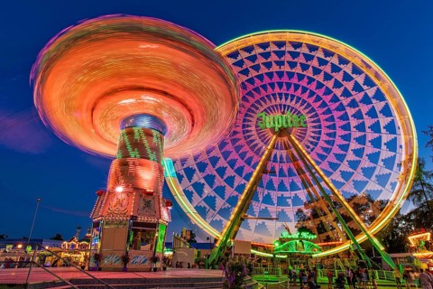 Chain carousel and Ferris wheel at night