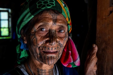 Chin woman with spiderweb tattoo