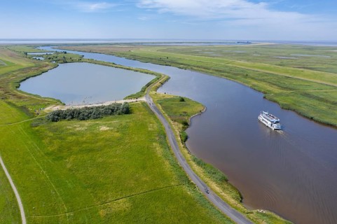 Drone shot with landscape at the Leyhoerner-Sieltief and tourist ship