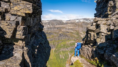 Hiker on a hiking trail to Innerdalstarnet
